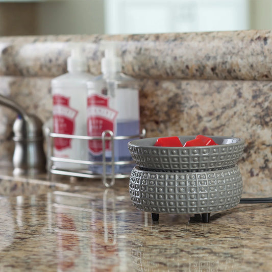 Elektrische Slate Geurwarmer op een aanrechtblad met granieten look. Strakke, grijze warmer met vlamvrije functie.